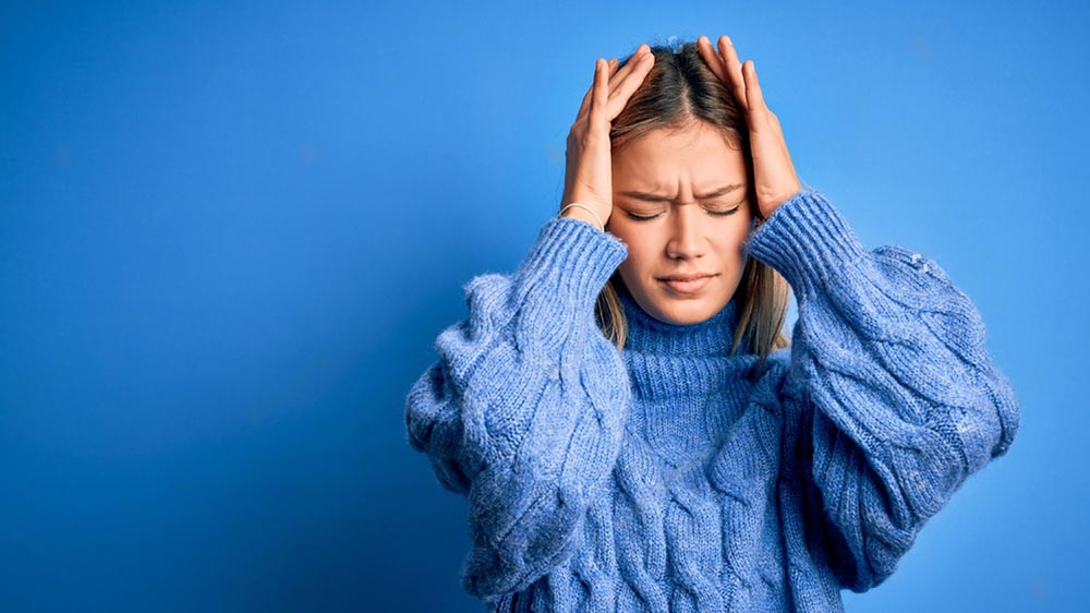 une femme stressée avec un pull bleu